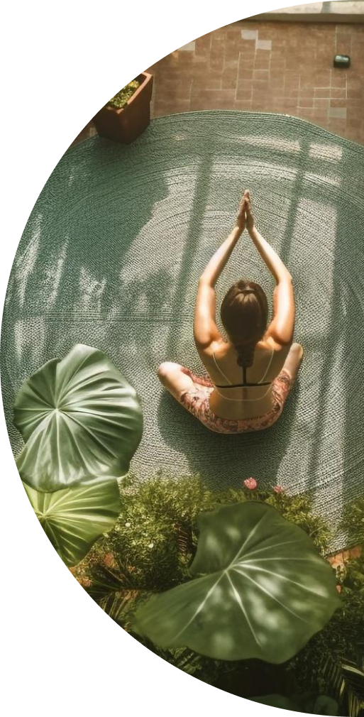 Person meditating surrounded by plants